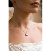 Gold-plated sterling silver Elaine pendant featuring a cushion-cut cubic zirconia in a stone-encrusted basket setting.