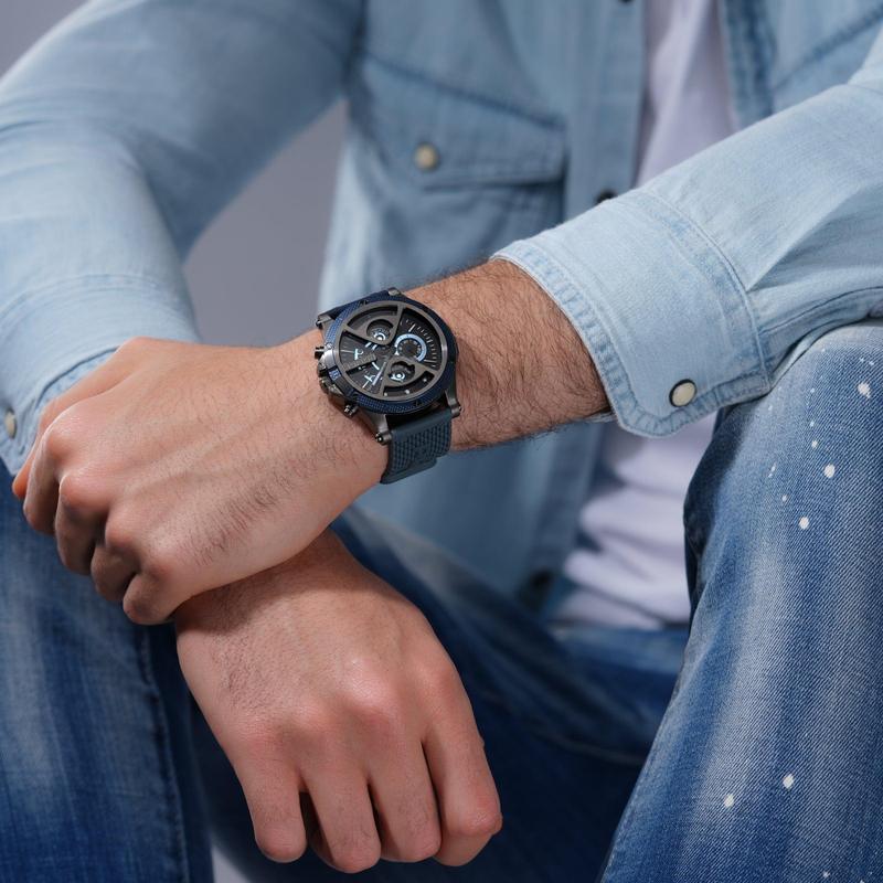 Police Surigao men's watch with a bold gold case, matte black sunray dial, and blue silicone strap on a model's wrist.