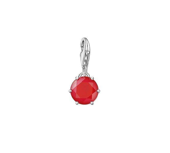 Thomas Sabo sterling silver charm featuring a vibrant, round-cut red coral stone in a classic claw setting.