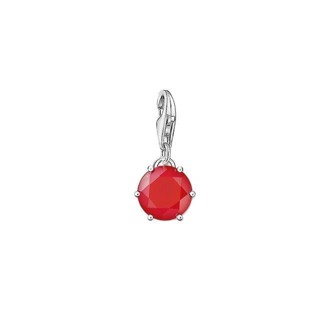 Thomas Sabo sterling silver charm featuring a vibrant, round-cut red coral stone in a classic claw setting.
