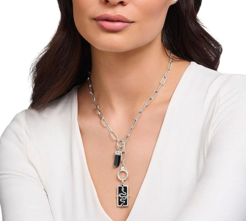 Thomas Sabo rectangular silver pendant featuring a 3D snake, black enamel, and colorful stones worn on a chain.