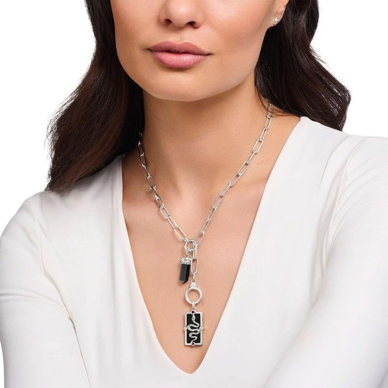Thomas Sabo rectangular silver pendant featuring a 3D snake, black enamel, and colorful stones worn on a chain.
