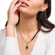 Thomas Sabo hexagon onyx pendant in 18k yellow-gold plated silver with cosmic engravings and colorful stone accents.